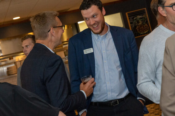 Kevin Hatcher smiles mid conversation with Todd Feland at Ely's Ivy in downtown Grand Forks.