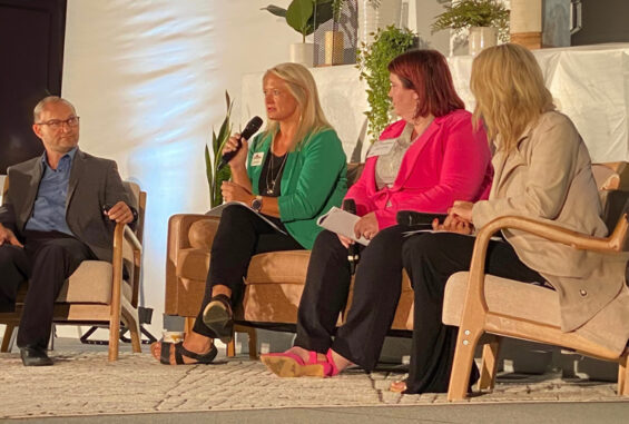 Four people sit on a stage at the EDND Conference in Bowman North Dakota discussing workforce in economic development.