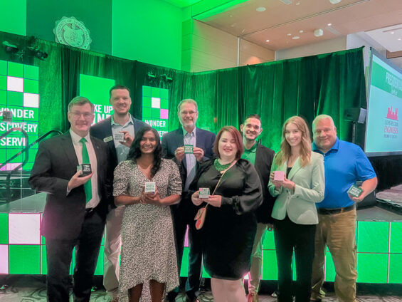 The Grand Forks Region EDC staff stand together with UND President Armacost at the Wake Up to UND event.
