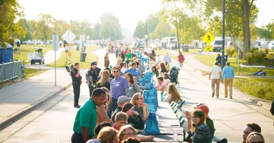 Community members gather at one long table with seats for up to 1,000 people at the Longest Table event in Grand Forks North Dakota.
