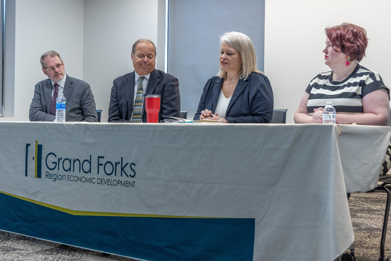 From left to right, Keith Lund, EDC President & CEO; Barry Wilfhart, Chamber of GF/EGF President & CEO; Dawn Mandt, Executive Director of Red River Regional Council; Becca Cruger, EDC Director of Workforce Development sit at a table with an EDC table cloth.