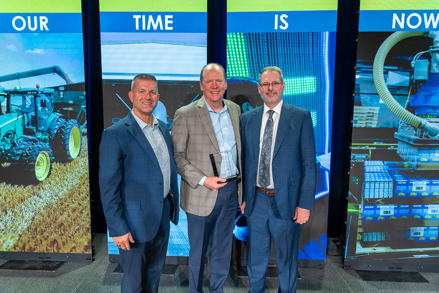 EDC Board Chair John Oncken, 2024 Impact Award Recipient Karl Bollingberg, and EDC president & ceo Keith Lund stand together.