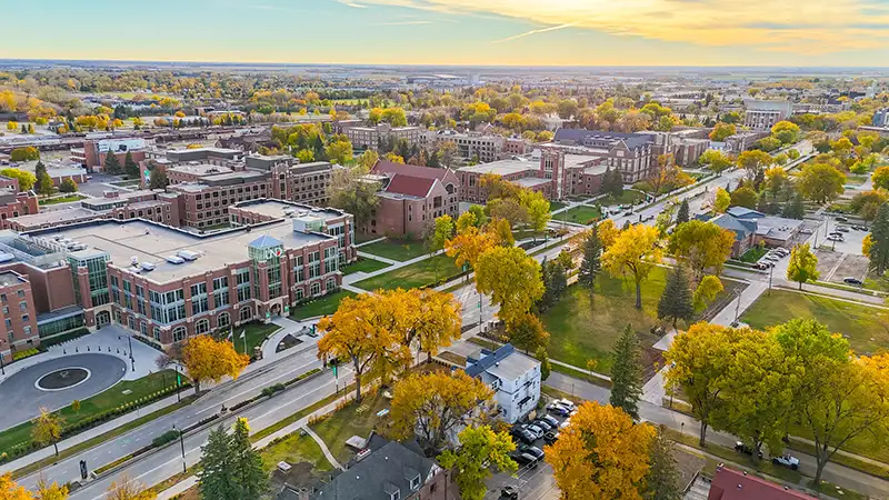 A drone shot of the UND Memorial Union and the surrounding buildings as the sun sets.