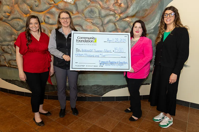 Representatives from the UND Center for INNOVAtion and Experiential Learning Center, Community Foundation of GF/EGF and Region, and EDC holds a $15,000 check for the InternGF Summer Cohort.