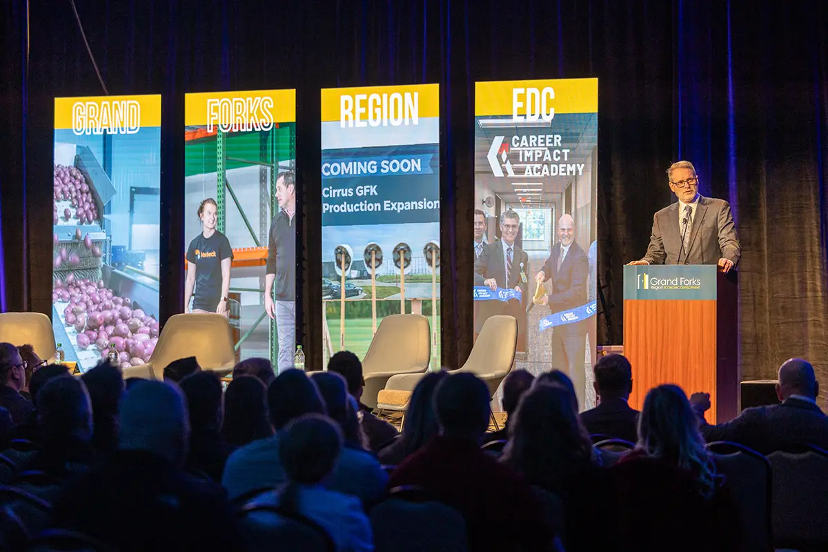 EDC President & CEO Keith Lund speaks at a podium welcoming guests to the annual meeting.